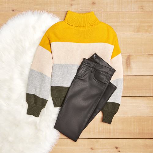 friendsgiving outfit ideas: striped sweater and leather denim